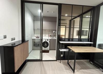 Modern apartment interior showing kitchen and small dining area