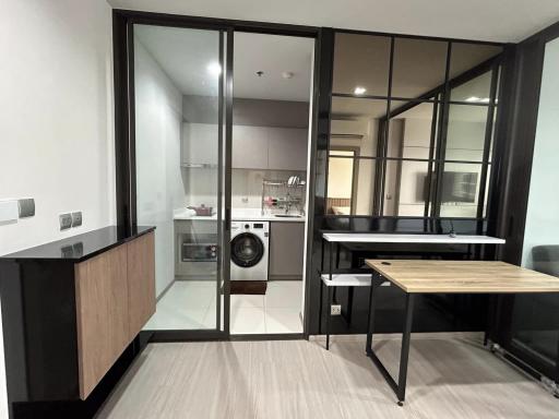 Modern apartment interior showing kitchen and small dining area