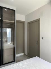 Bright and modern bedroom with large window and mirrored wardrobe