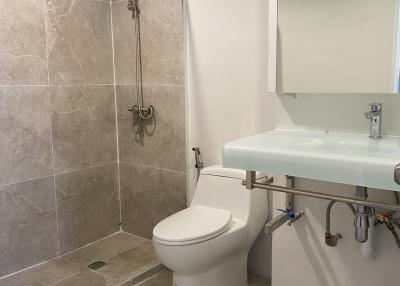 Modern bathroom with walk-in shower and floating sink