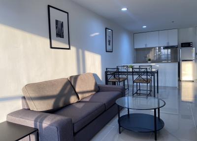 Modern living room with open concept to the dining area and adjacent kitchen