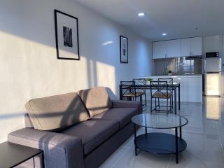 Modern living room with open concept to the dining area and adjacent kitchen