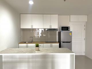 Modern kitchen with stainless steel appliances and white cabinetry