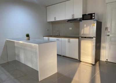 Modern kitchen with white cabinets and stainless steel appliances