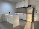 Modern kitchen with white cabinets and stainless steel appliances