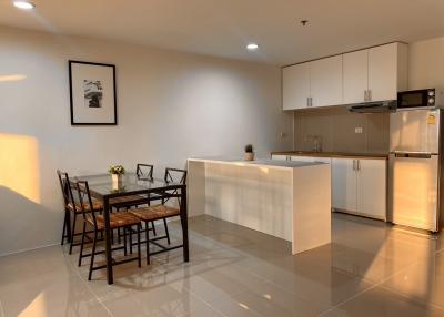 Modern kitchen with dining table in a bright apartment