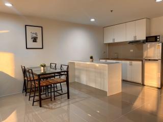 Modern kitchen with dining table in a bright apartment