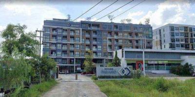 Exterior view of a modern apartment building with signage