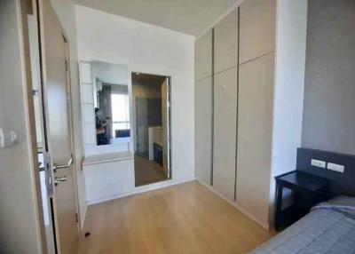 Bright bedroom with large wardrobe and mirror