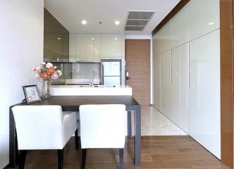 Modern kitchen with dining area and wooden accents