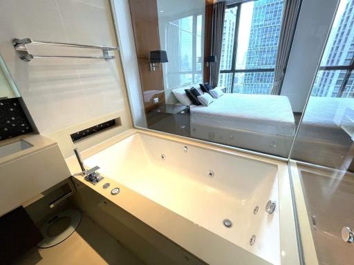 Modern bathroom with whirlpool tub, separate shower, and city view