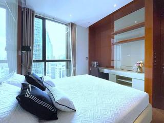 Modern bedroom with large windows and city view