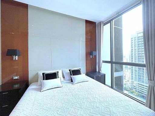 Modern bedroom with large window and city view