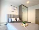 Modern bedroom with a large bed and mirrored wardrobe