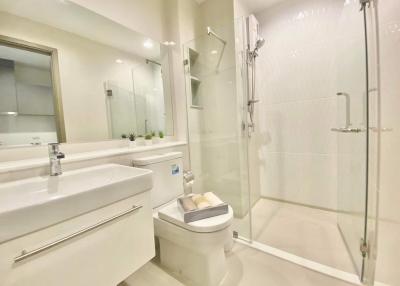 Modern bathroom with white fixtures and glass shower