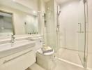 Modern bathroom with white fixtures and glass shower