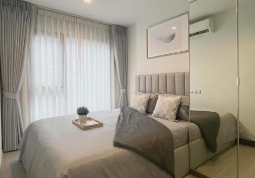 Elegant modern bedroom with neutral tones and natural lighting