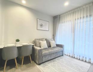 Contemporary living room with dining area natural light