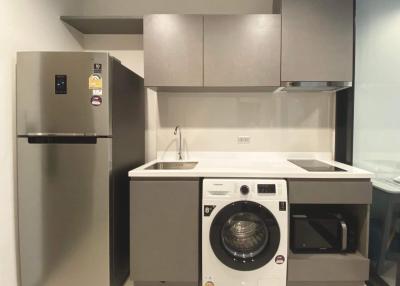 Modern kitchen with stainless steel appliances and white cabinetry