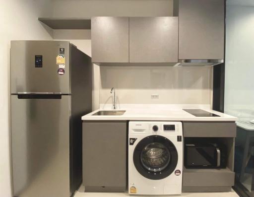 Modern kitchen with stainless steel appliances and white cabinetry