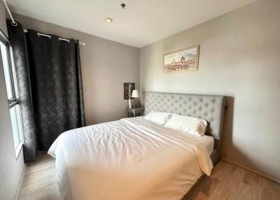 Cozy bedroom with natural lighting and wooden floor