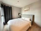 Cozy bedroom with natural lighting and wooden floor