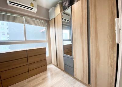 Compact bedroom with large window and built-in wardrobe