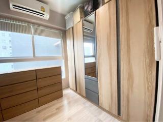 Compact bedroom with large window and built-in wardrobe