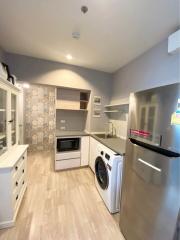 Modern kitchen with stainless steel appliances and patterned backsplash