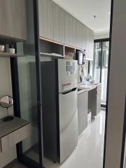 Modern kitchen with stainless steel refrigerator and ample cabinetry