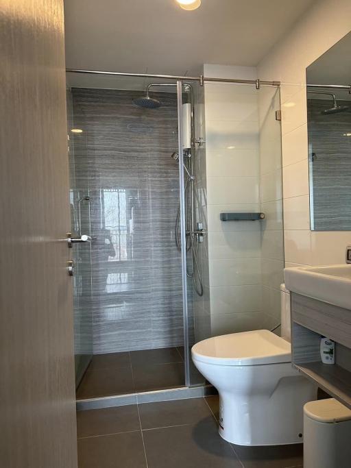 Modern bathroom with glass shower and ceramic fixtures