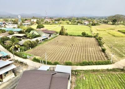 Aerial view of a rural landscape with agricultural fields and houses