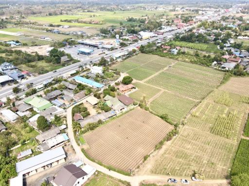 Aerial view of countryside with farmland, roads, and residential buildings