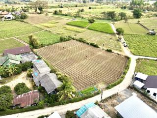 Aerial view of expansive agricultural land with surrounding buildings