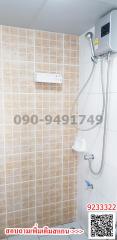 Modern bathroom with wall-mounted shower and tiled walls