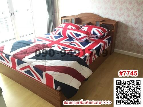 Cozy Bedroom with Union Jack Bedding and Wooden Furniture