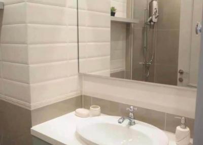 Modern bathroom with tiled walls and sleek fixtures