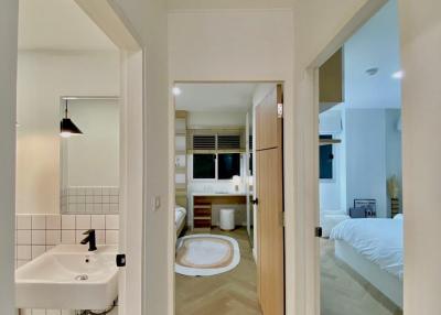 Hallway view towards bathroom and bedroom in modern home