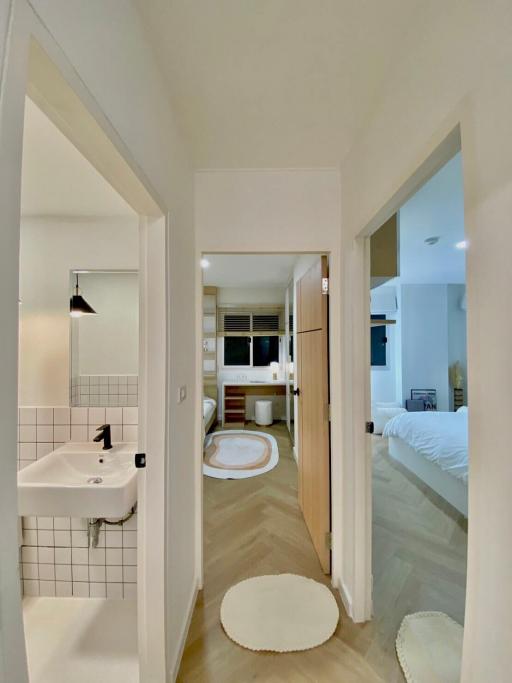 Hallway view towards bathroom and bedroom in modern home