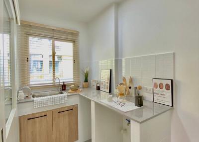 Bright modern kitchen with white tiles and wooden cabinetry