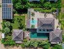 Aerial view of a luxury property with solar panels and swimming pool
