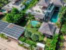 Aerial view of a luxurious residential property with lush greenery and solar panels