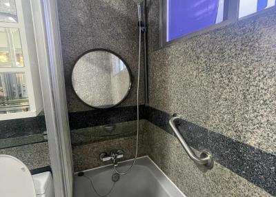 Modern bathroom with granite walls and a bathtub