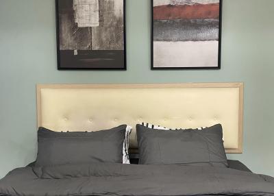 Cozy bedroom with modern wall art and neutral color palette