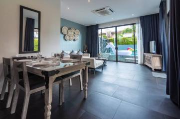 Modern dining area with open layout leading to outdoor space