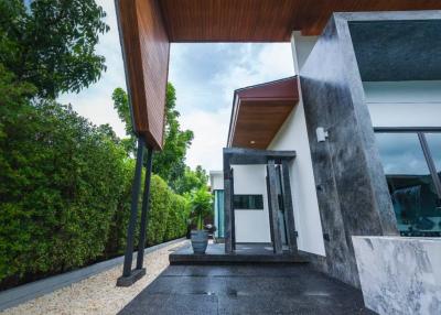 Modern home entrance with wooden ceiling and marble accents