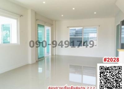 Spacious unfurnished interior of a modern building with large windows and glossy tiled floor