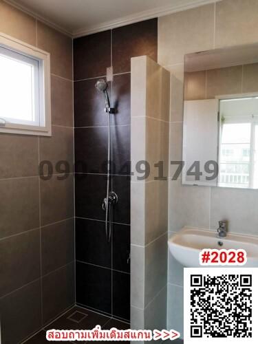 Modern bathroom with walk-in shower and brown tiling