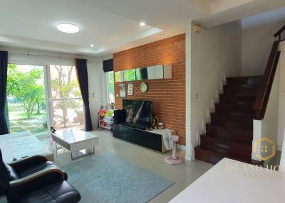 Spacious living room with staircase and natural light