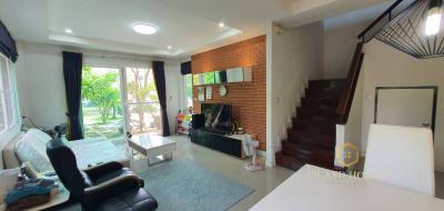 Spacious living room with staircase and natural light